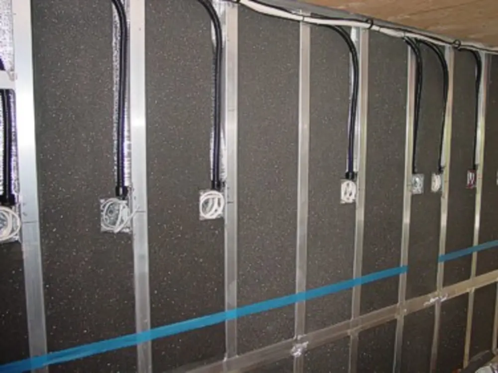 Exterior view of small fire truck showing cab, body compartments, and wheel/tire area.