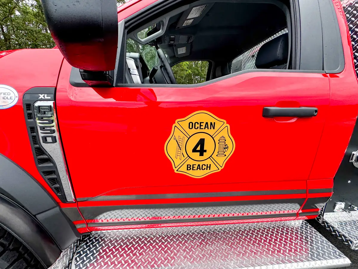 Driver-side profile of red brush truck, photo 13 of 179.