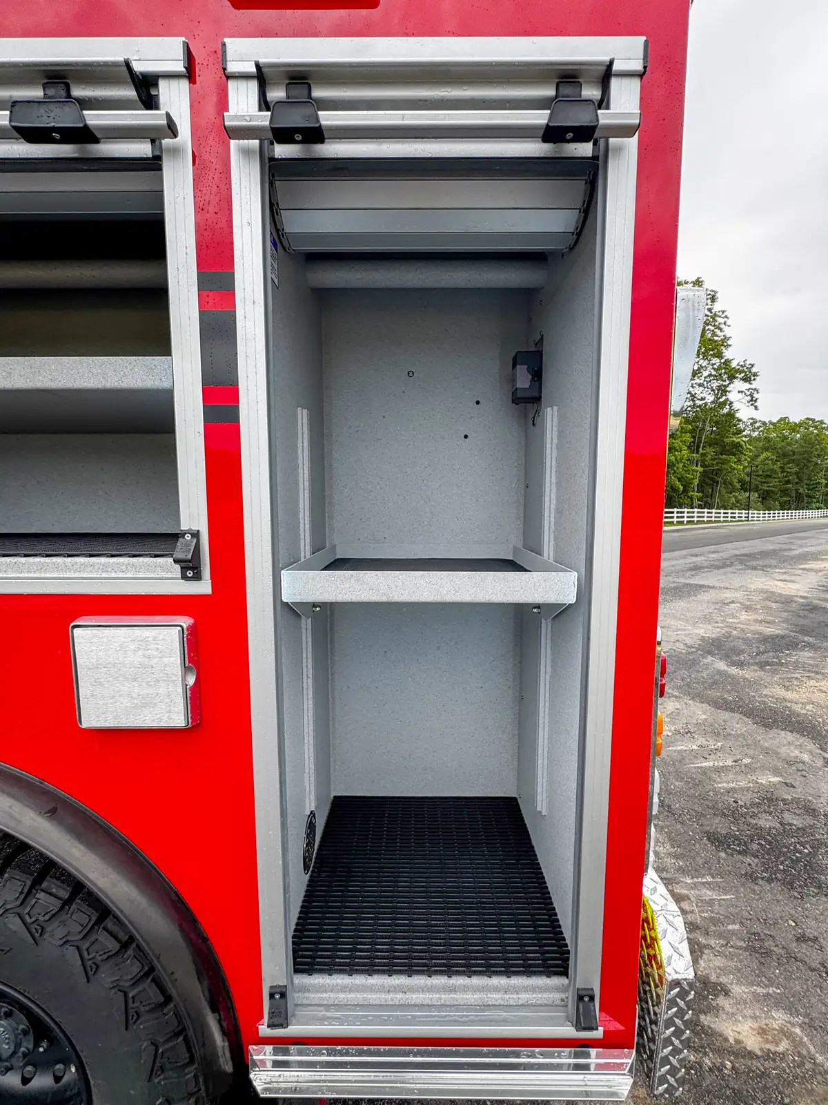 Driver-side profile of red brush truck, photo 23 of 179.