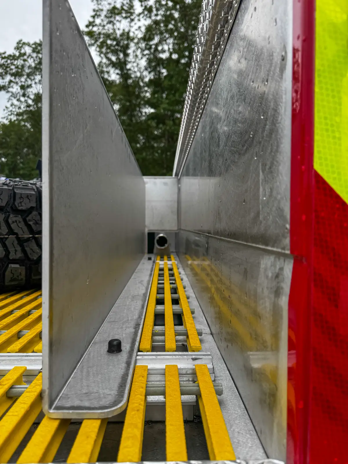 Driver-side profile of red brush truck, photo 33 of 179.