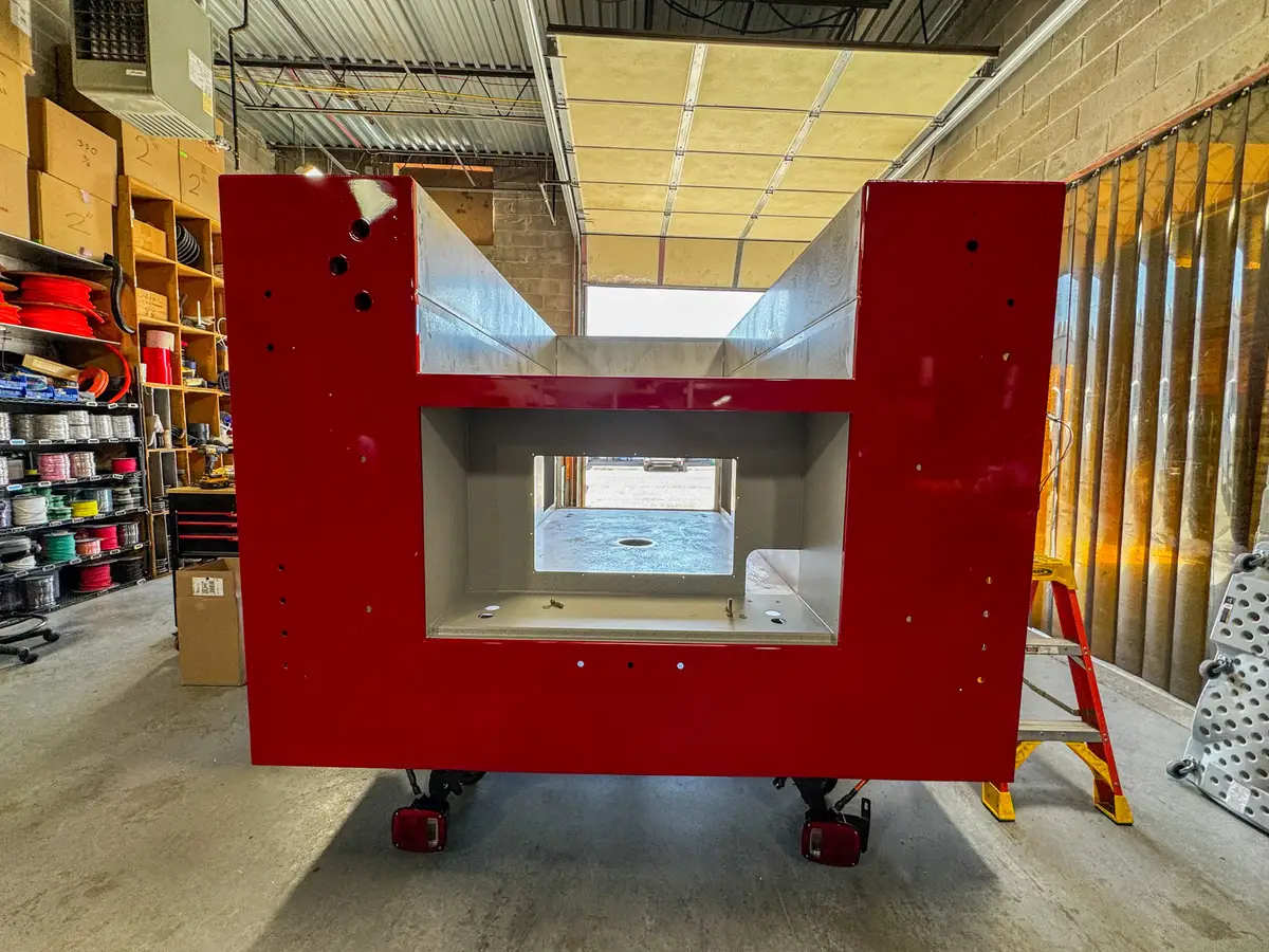 Side view of cab and body in assembly bay, photo 86 of 179.