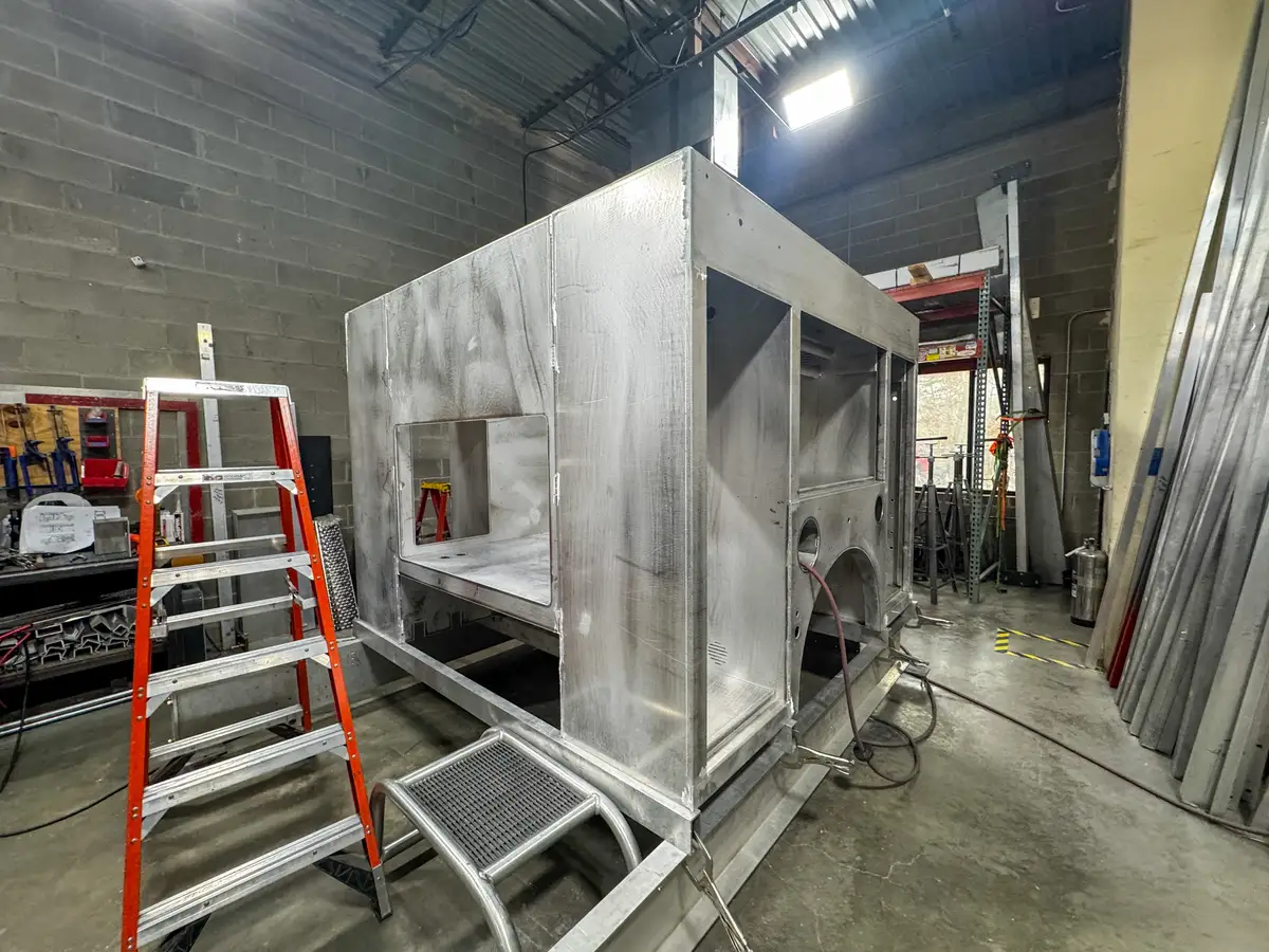 Partially assembled apparatus body on shop floor, photo 130 of 179.