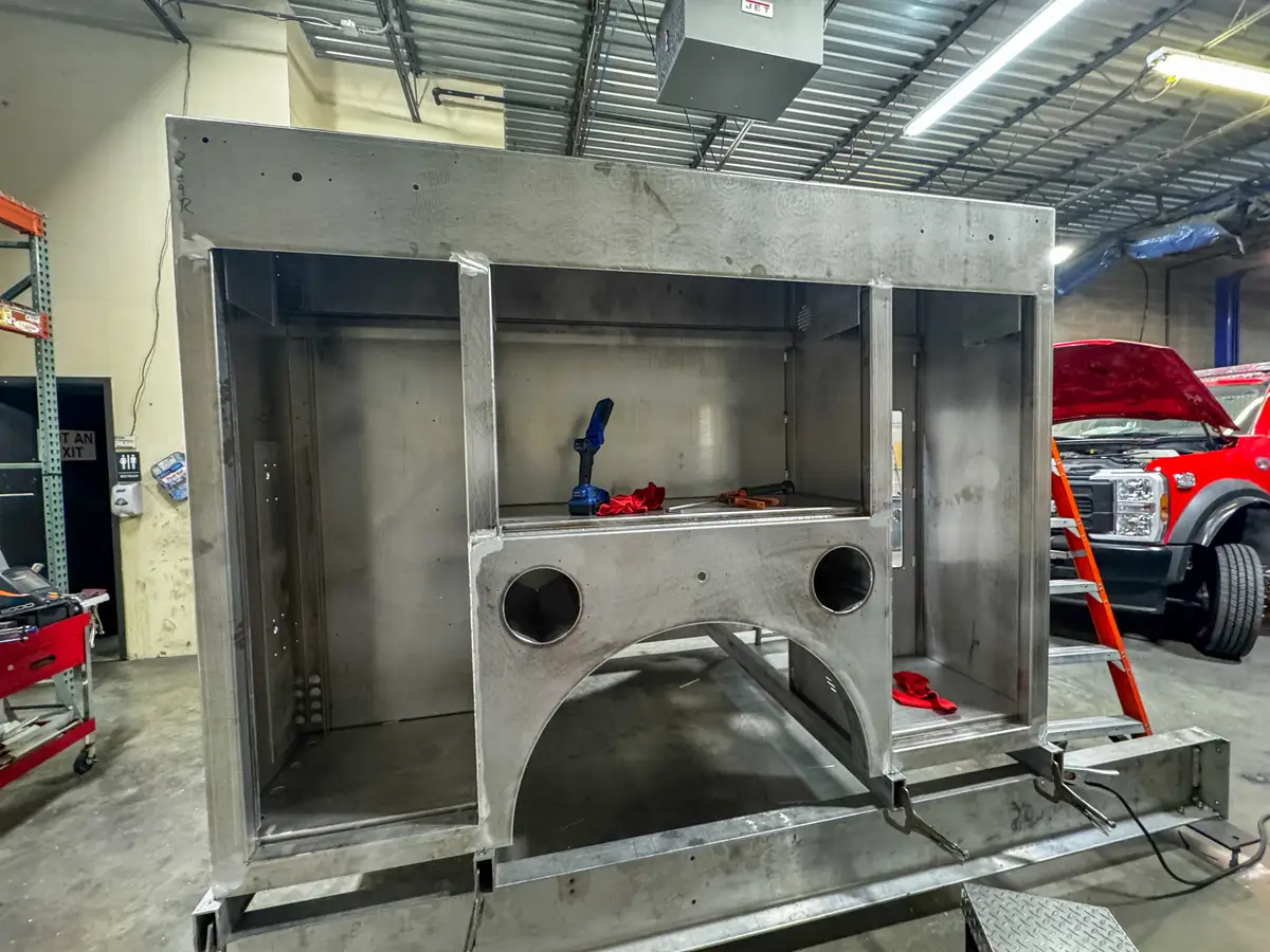 Side view of cab and body in assembly bay, photo 136 of 179.