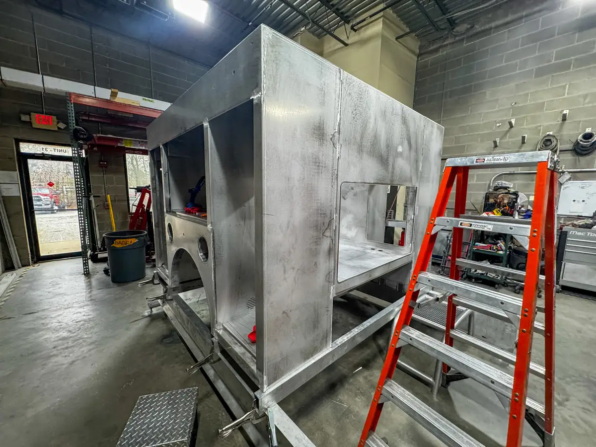 Body panels staged in production area, photo 138 of 179.