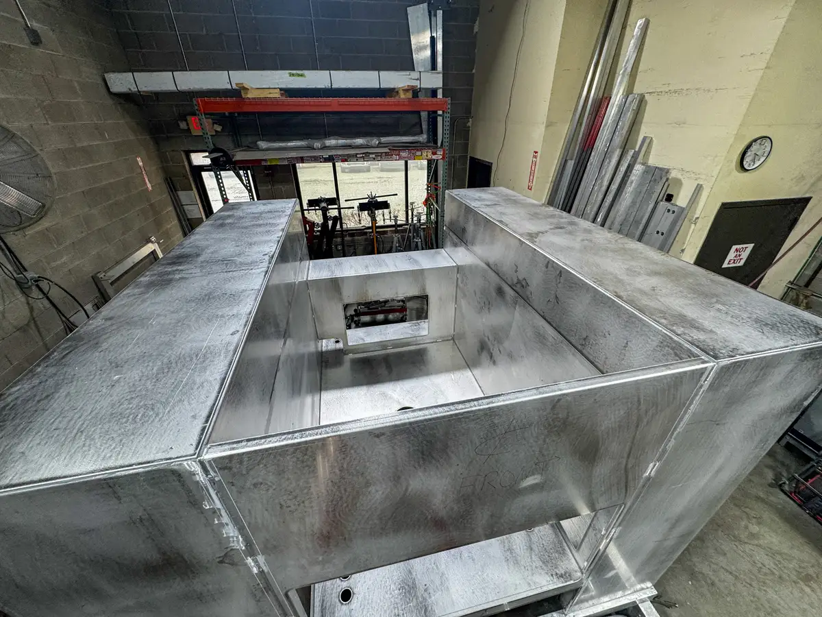 Partially assembled apparatus body on shop floor, photo 140 of 179.