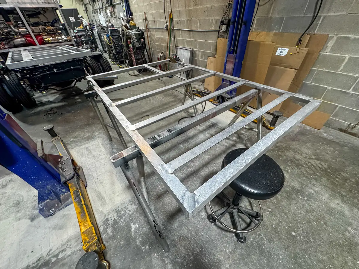 Unpainted aluminum compartment structure in shop, photo 142 of 179.
