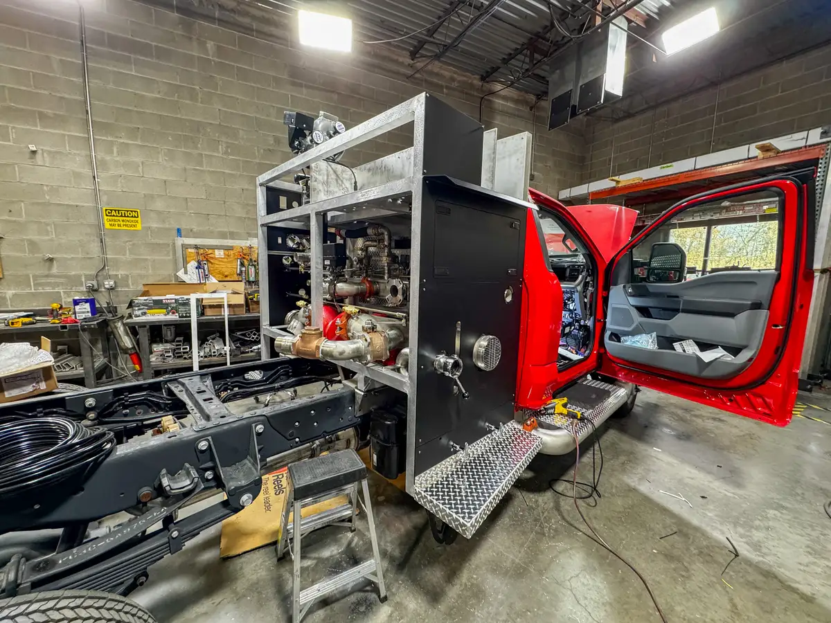 Side view of cab and body in assembly bay, photo 146 of 179.