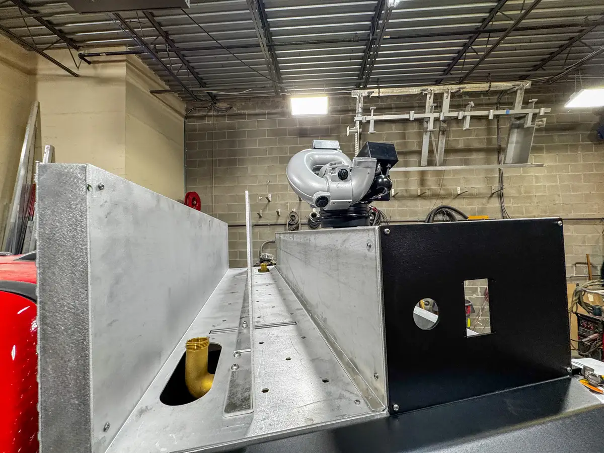 Side view of cab and body in assembly bay, photo 156 of 179.