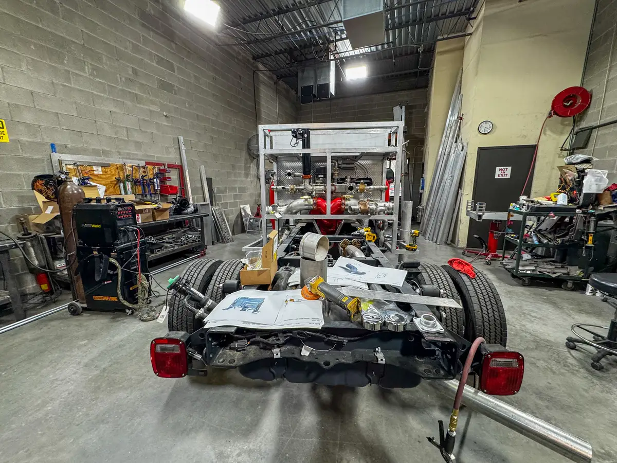 Side view of cab and body in assembly bay, photo 176 of 179.