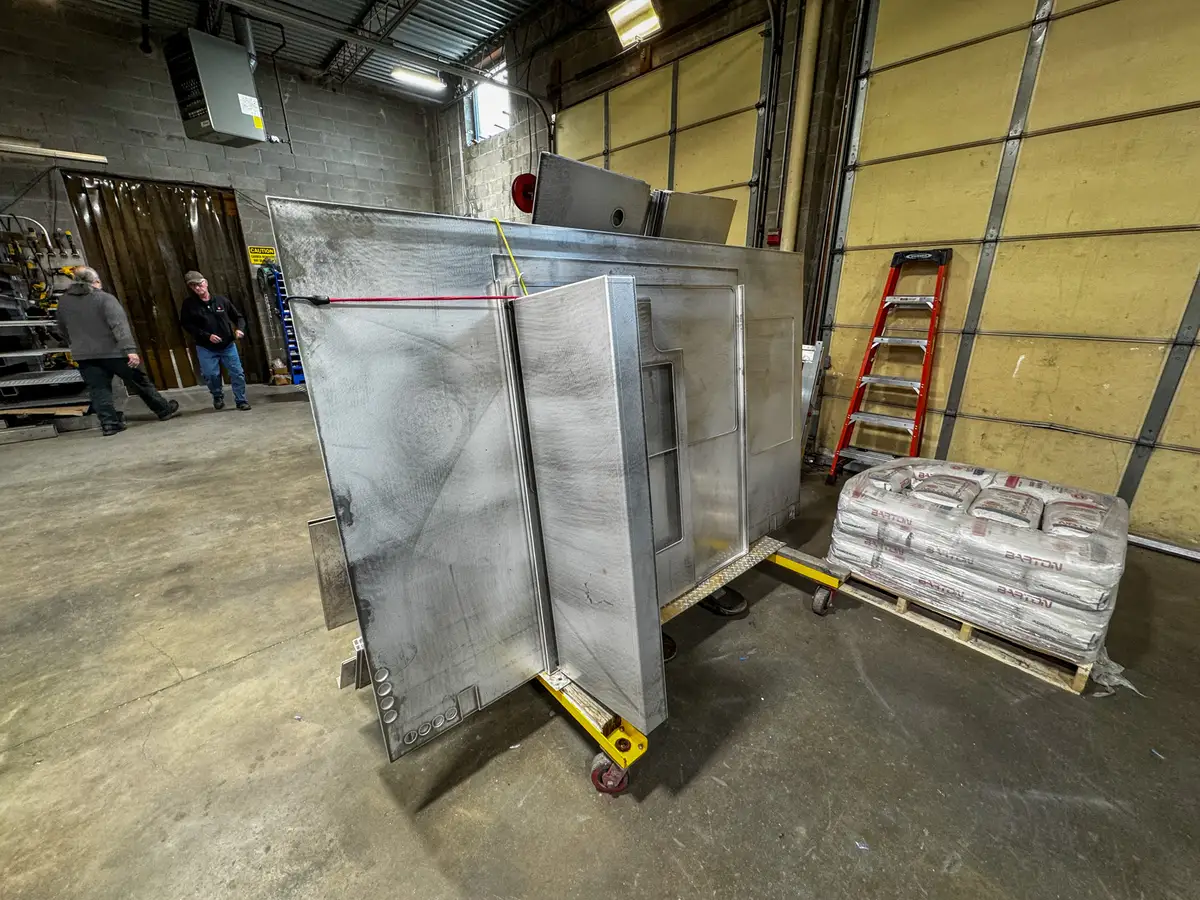 Body panels staged in production area, photo 178 of 179.