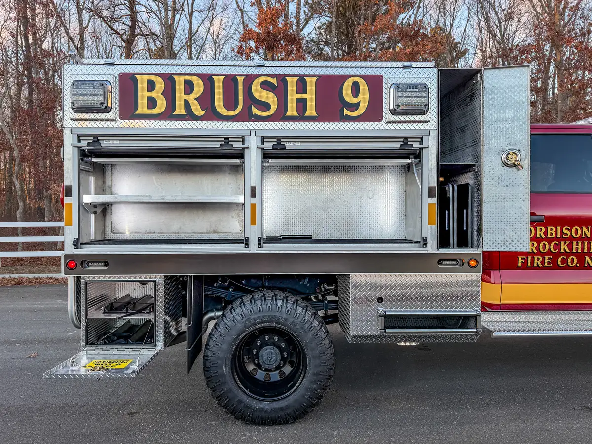 Driver-side view with lower rear step compartment open.