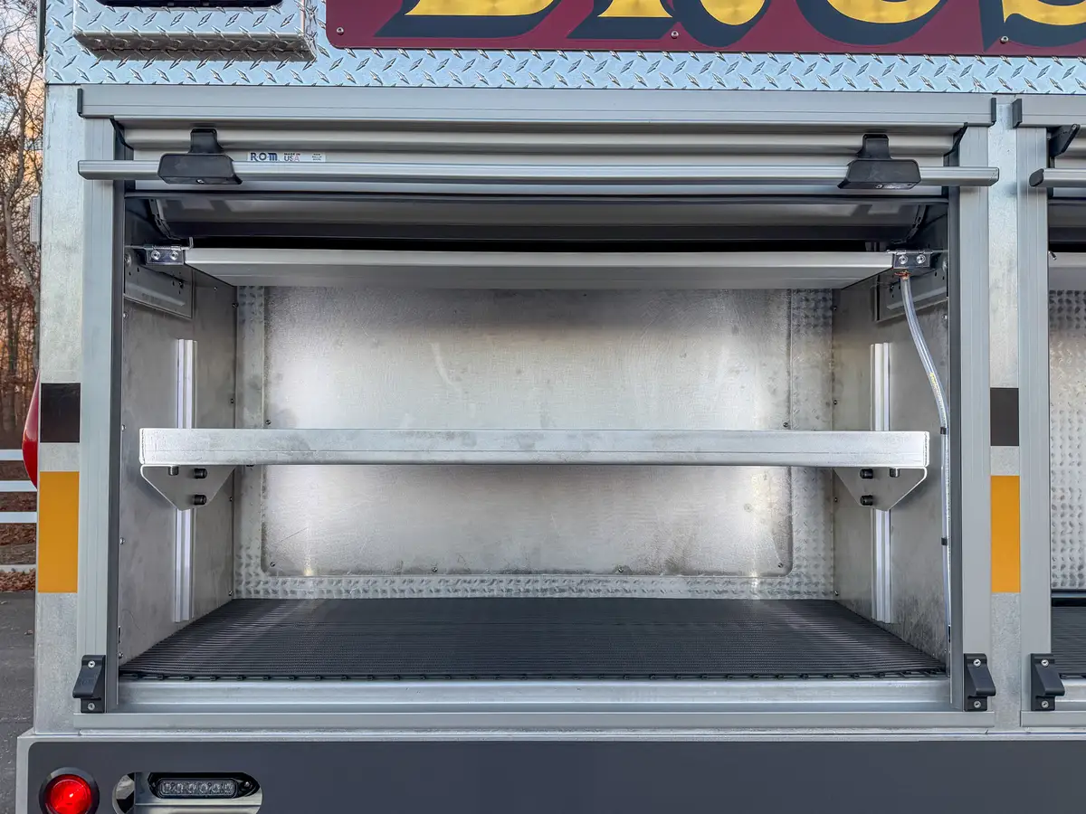 Open side compartment with shelves and empty storage space.