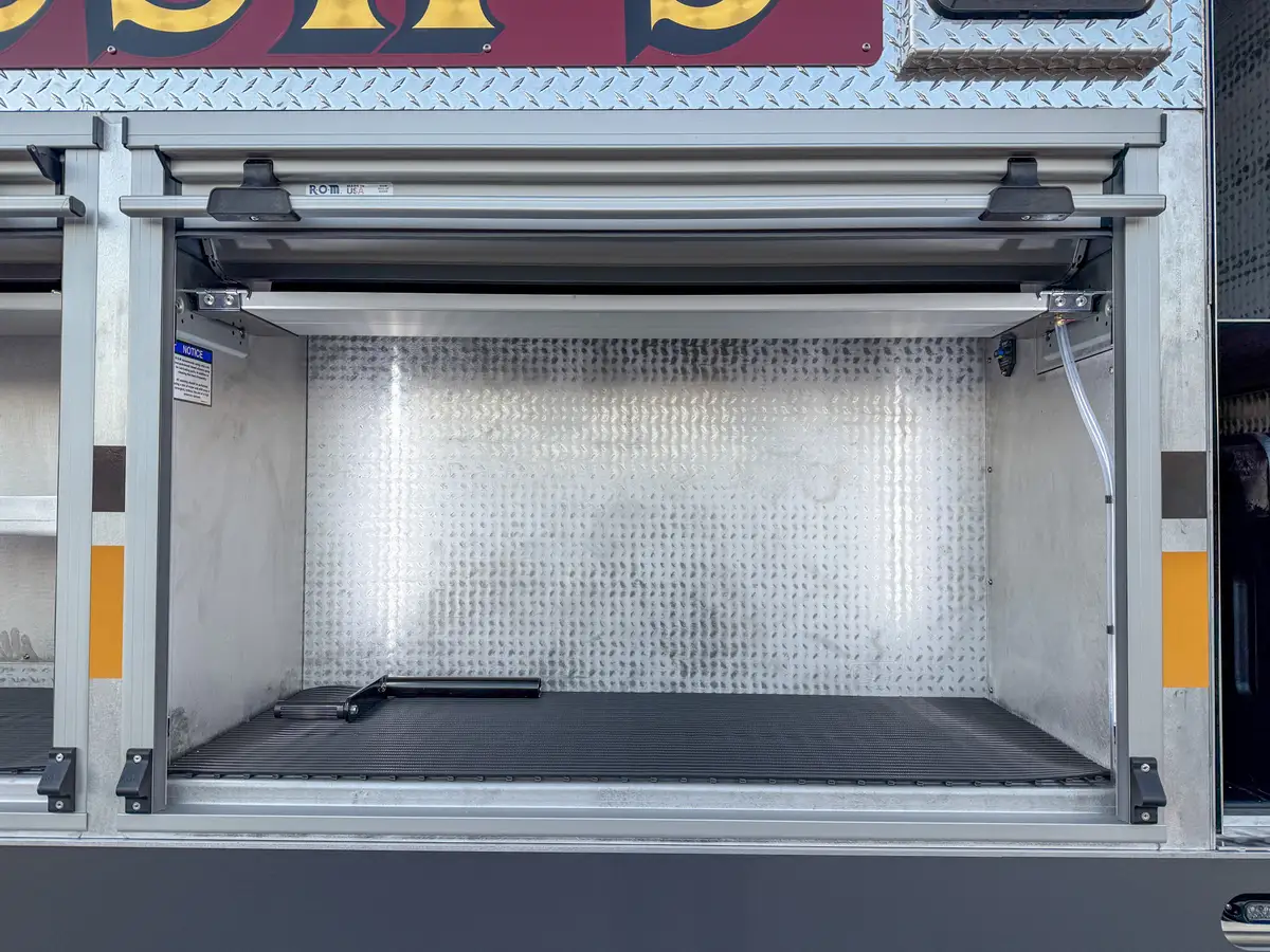 Open side shelf compartment above rear wheel area.