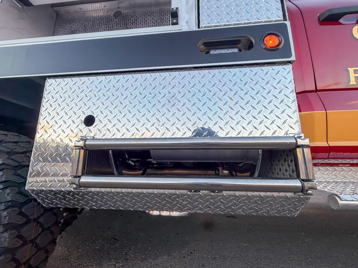 Lower side drawer compartment opened beneath body panel.