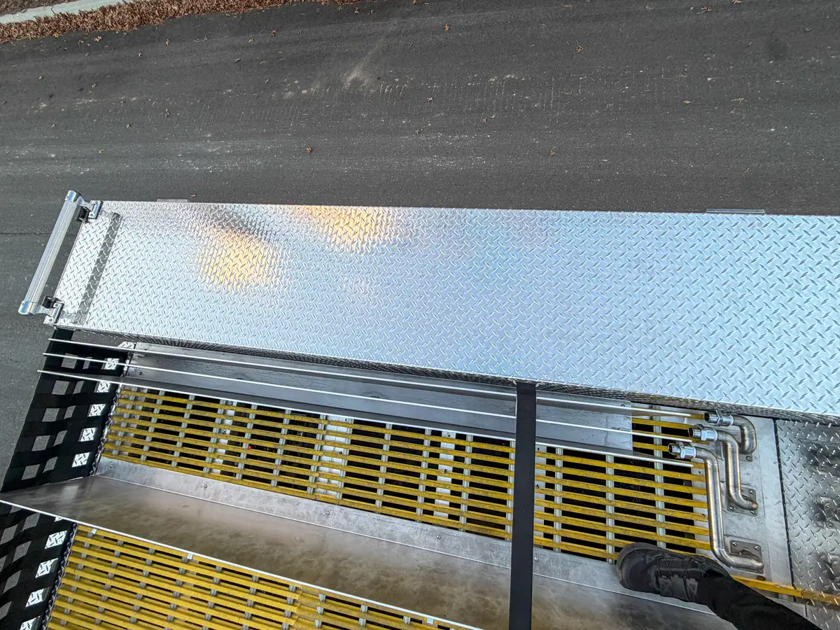 Rear upper deck edge with grated walkway and railing.