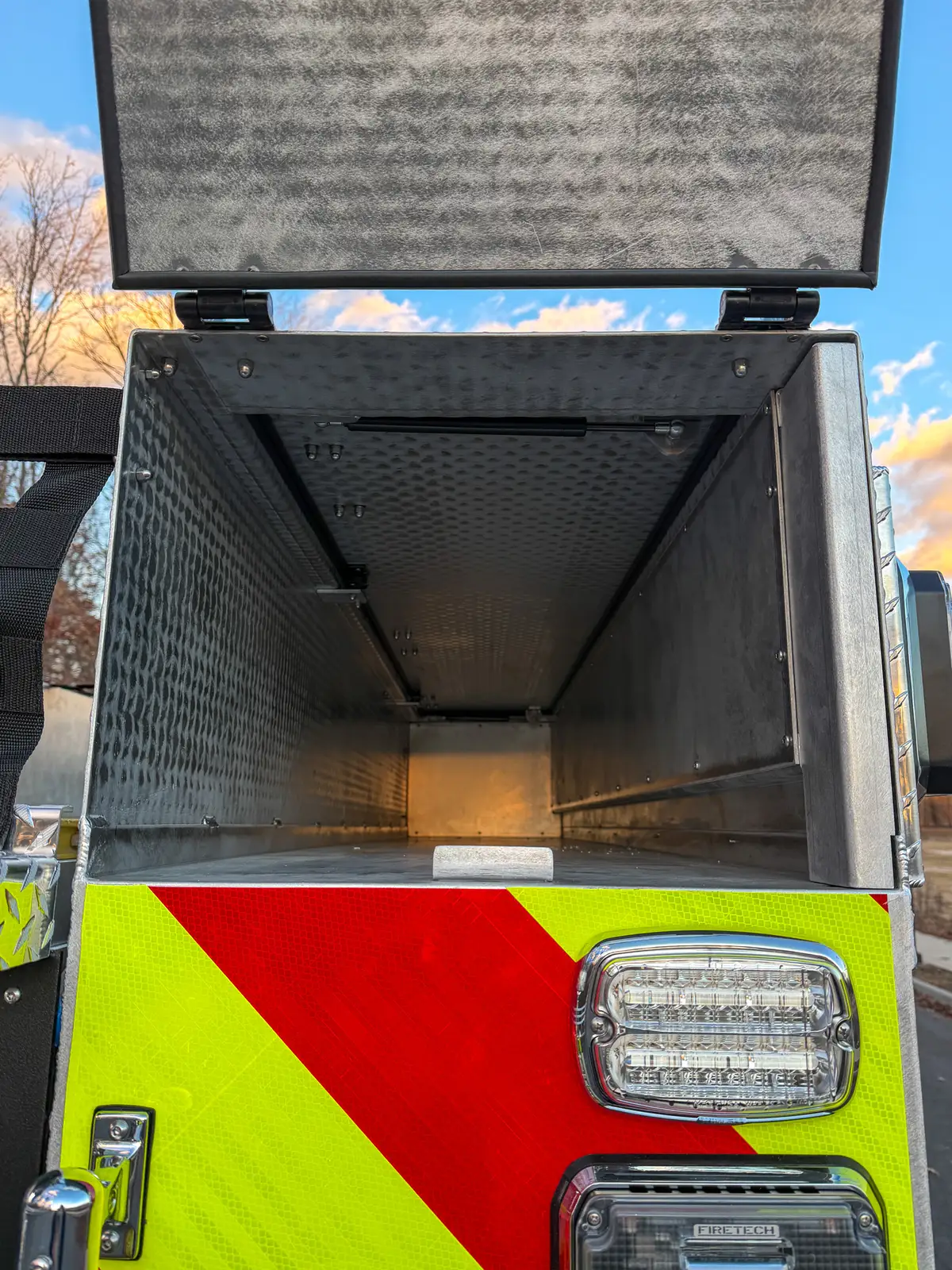 Open rear tunnel compartment with interior light on.