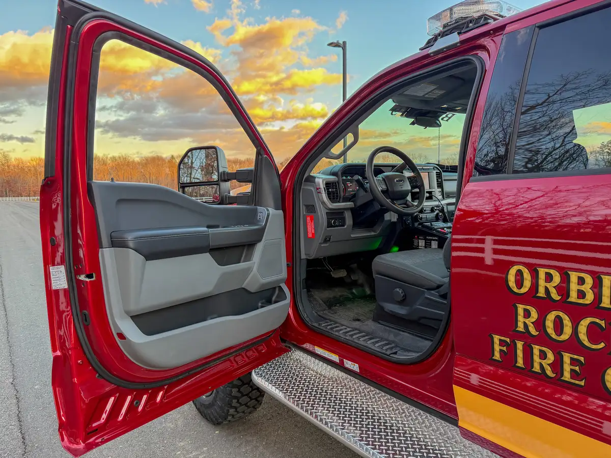 Open driver door showing front seat and cab entry.