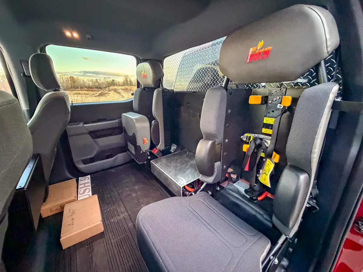 Rear cabin bench and equipment mounts behind front seats.
