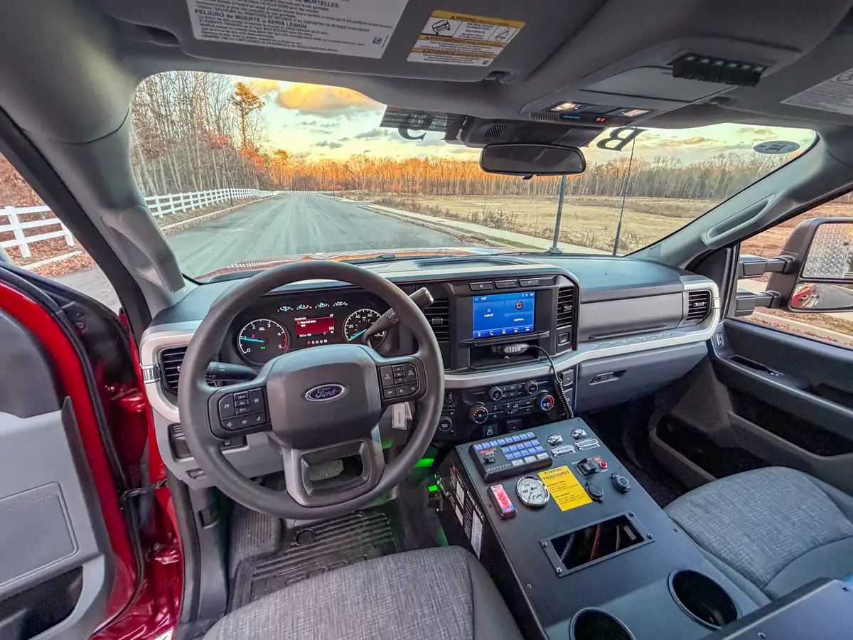 Driver-side cockpit angle with steering wheel and instrument panel.