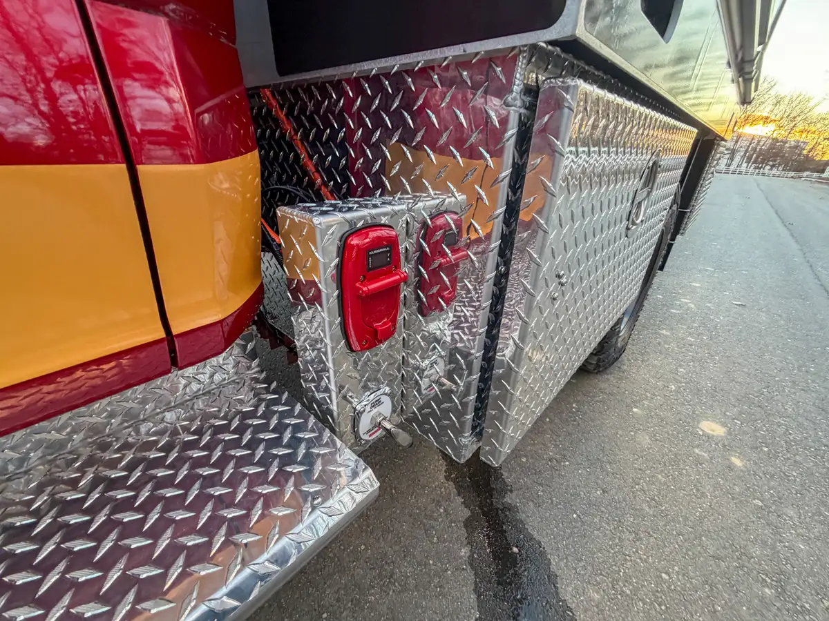 Rear side corner with diamond-plate panel and marker light.