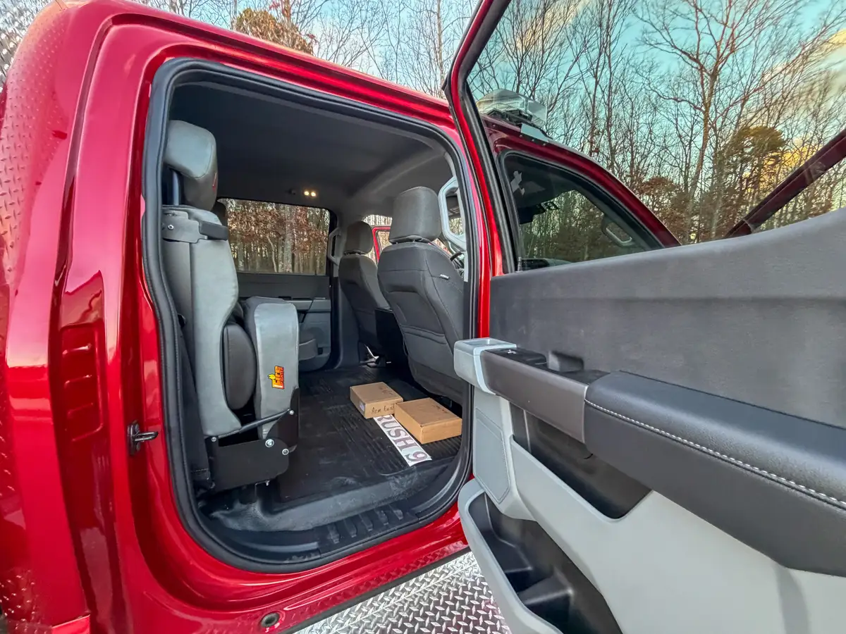 Open rear door with second-row seats and floor area.