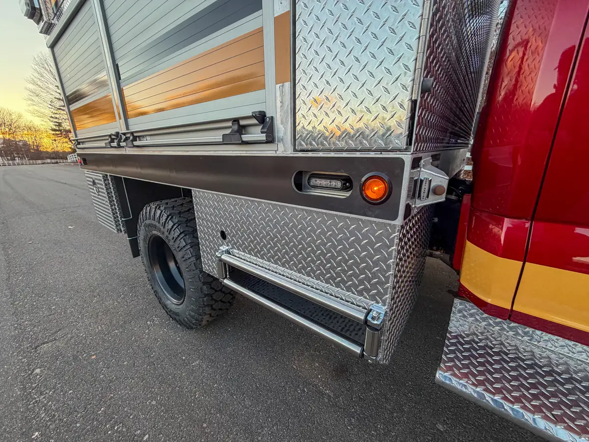 Side body panel near rear wheel and roll-up compartment section.