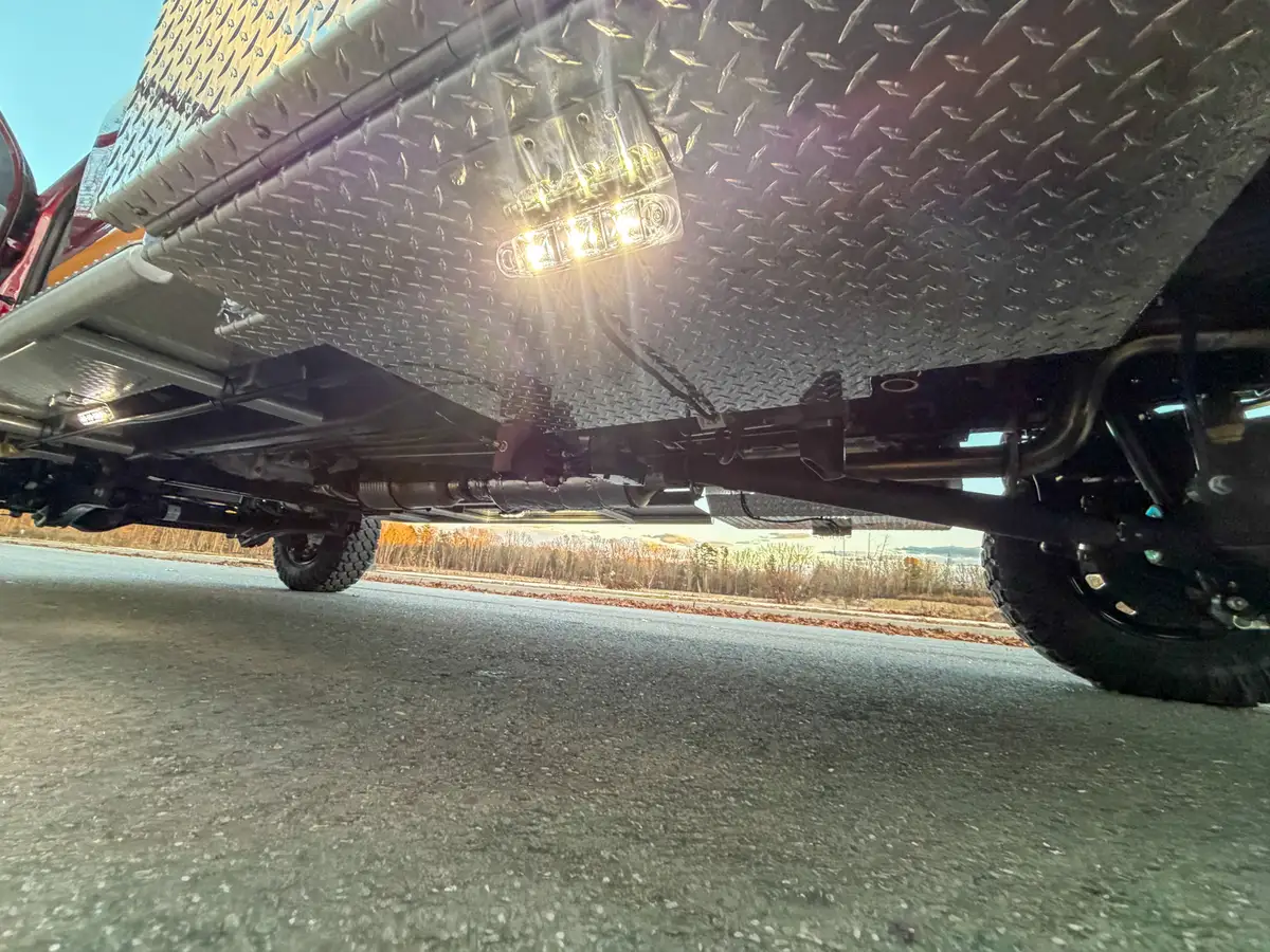 Underbody side view with mounted lights beneath body.