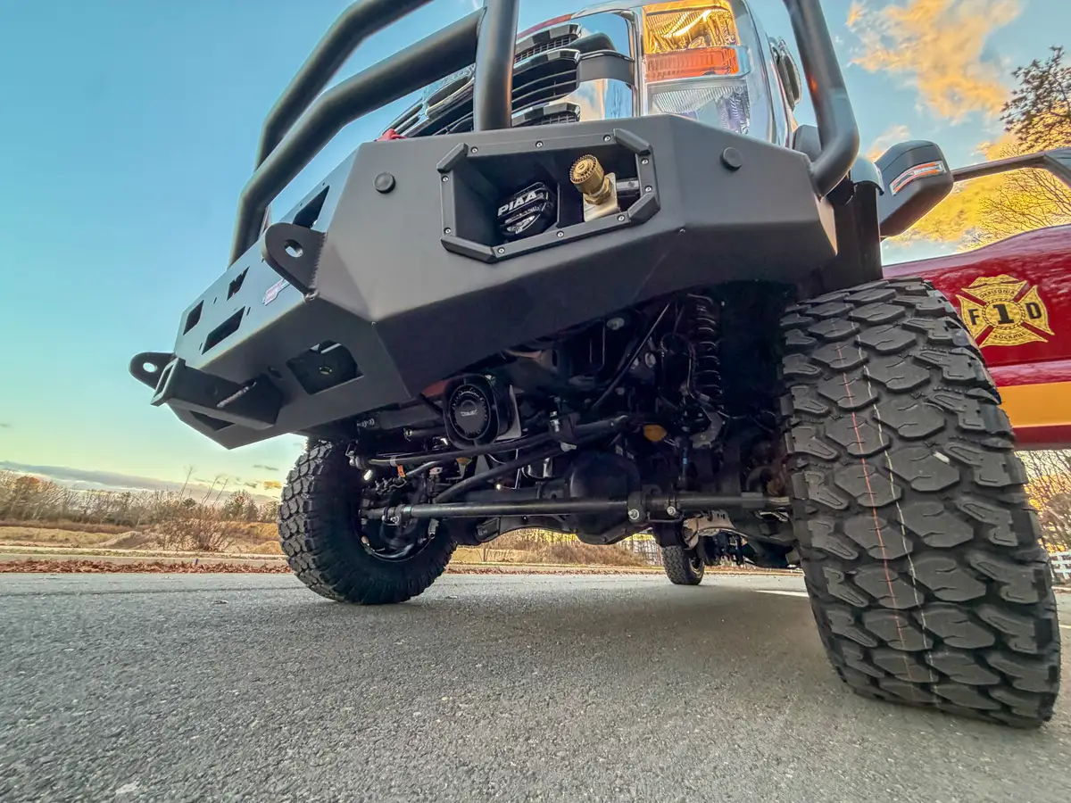 Low front underbody angle showing bumper and axle.