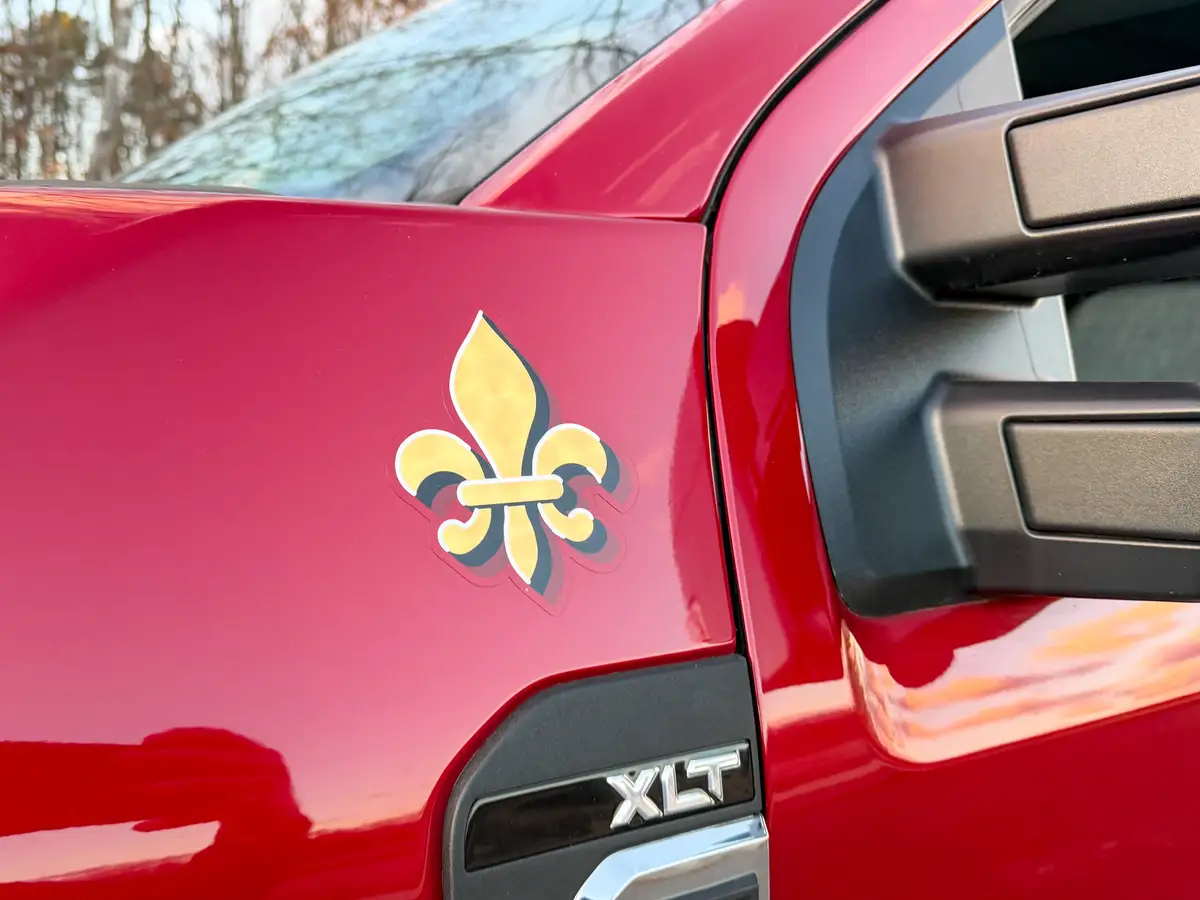 Cab side badge close-up with fleur-de-lis emblem.