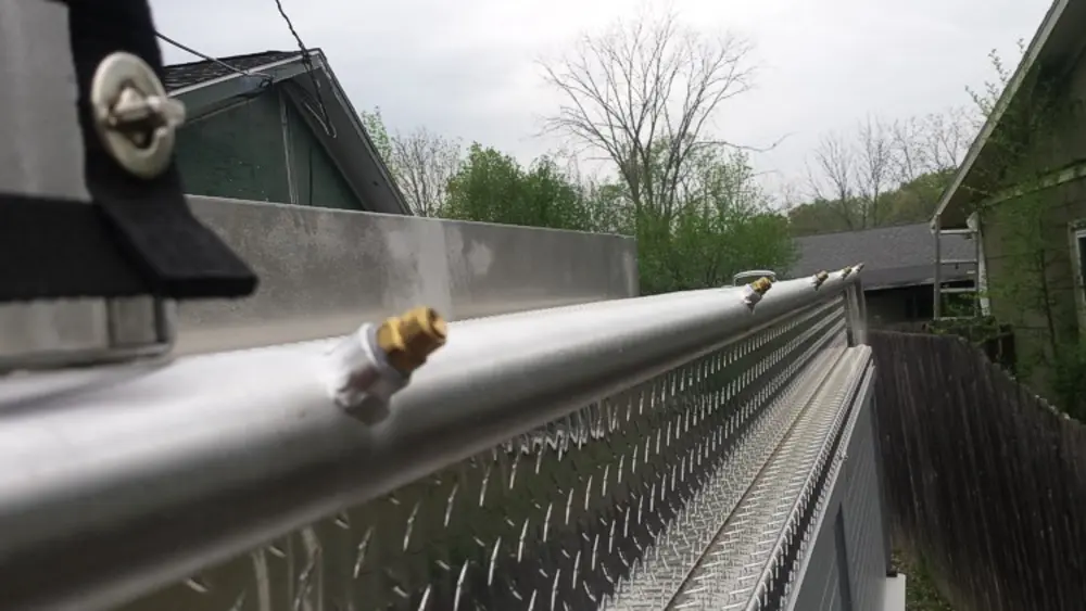 Exterior view of small fire truck showing cab, body compartments, and wheel/tire area.