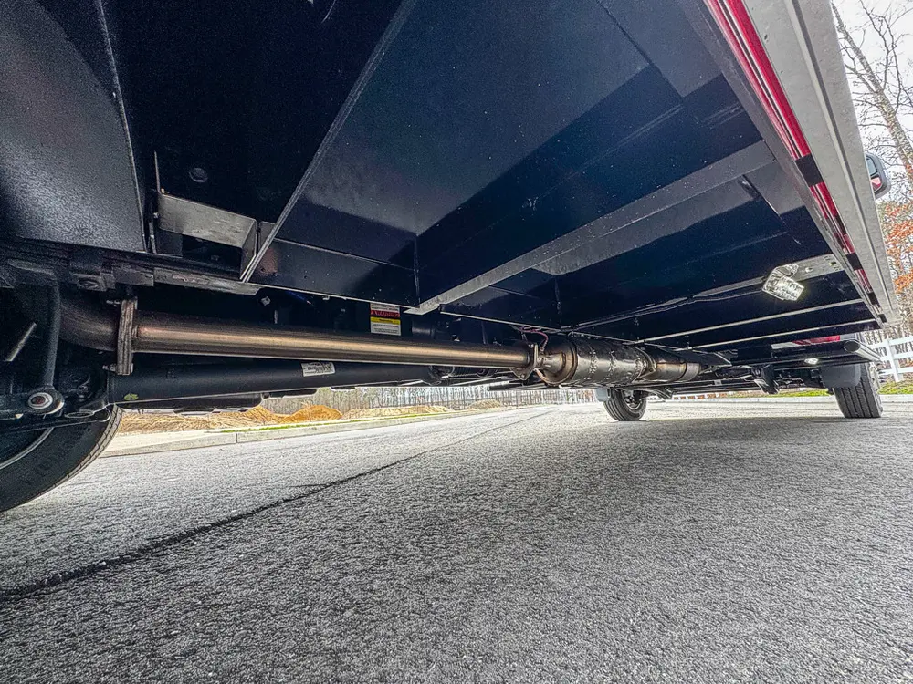 Exterior view of small fire truck showing cab, body compartments, and wheel/tire area.