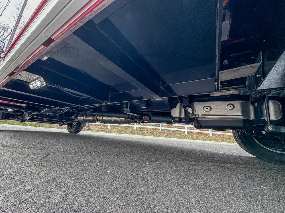 Exterior view of small fire truck showing cab, body compartments, and wheel/tire area.