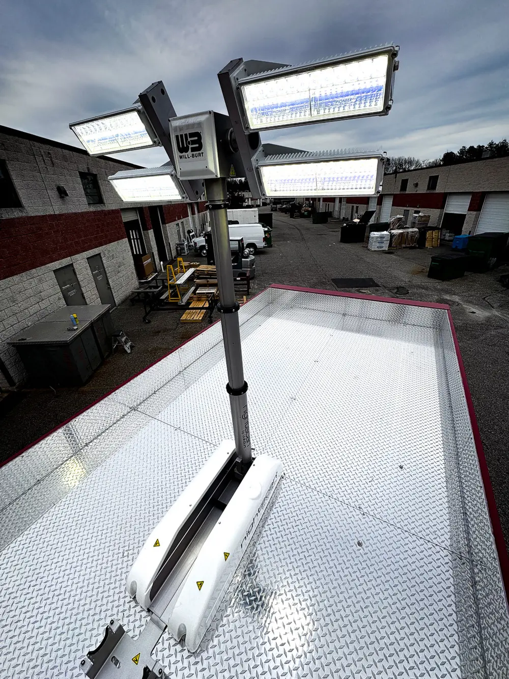 Exterior view of small fire truck showing cab, body compartments, and wheel/tire area.