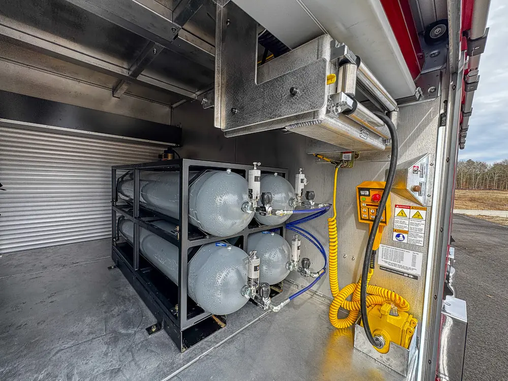 Air cylinder bank and control pendant beneath slide mechanism.