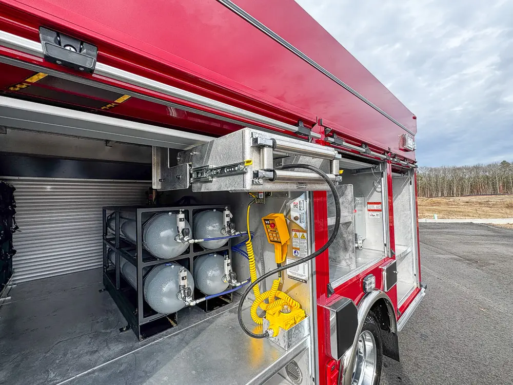 Side compartment with extended rack, air cylinders, and nearby shelving.