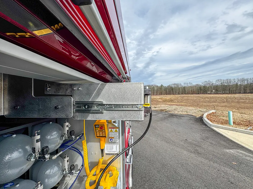 Close side view of slide rail hardware over air cylinder rack.