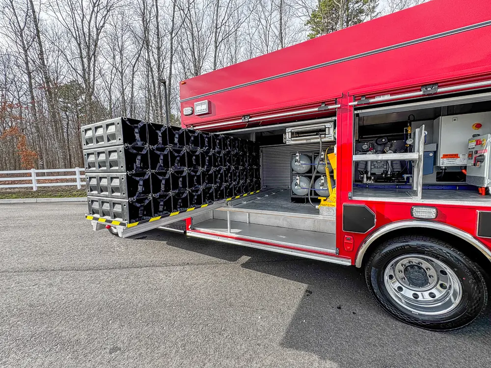 Wide right-side view of extended rack with equipment bays open.
