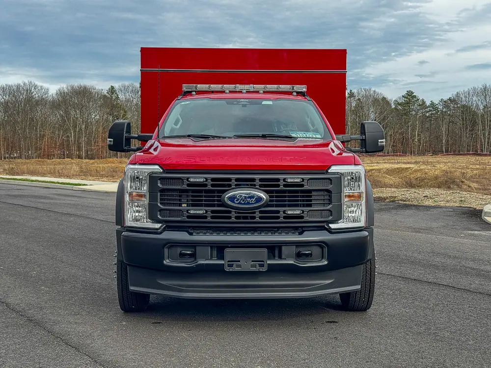 Head-on front view showing grille, bumper, and light bar.
