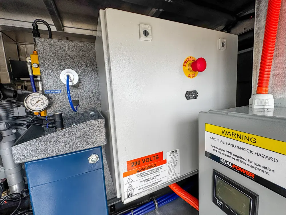 Close view of 230-volt electrical enclosure and adjacent components.