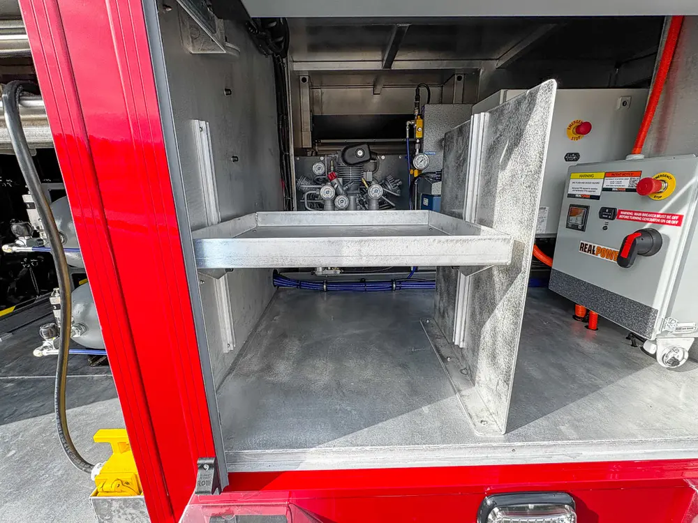 Open bay with fixed metal shelf and equipment behind it.