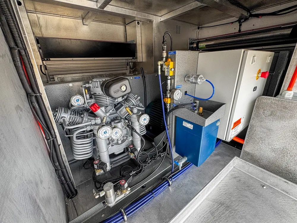 Compressor and support equipment mounted inside side compartment.