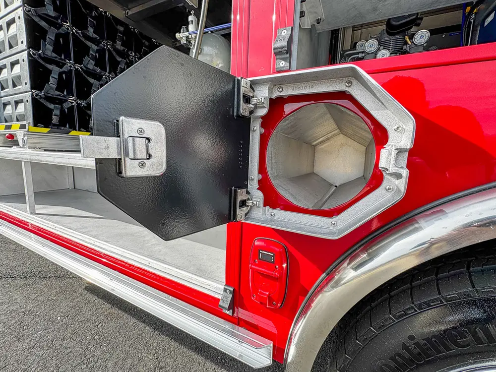 Open side utility tube compartment near rear wheel.