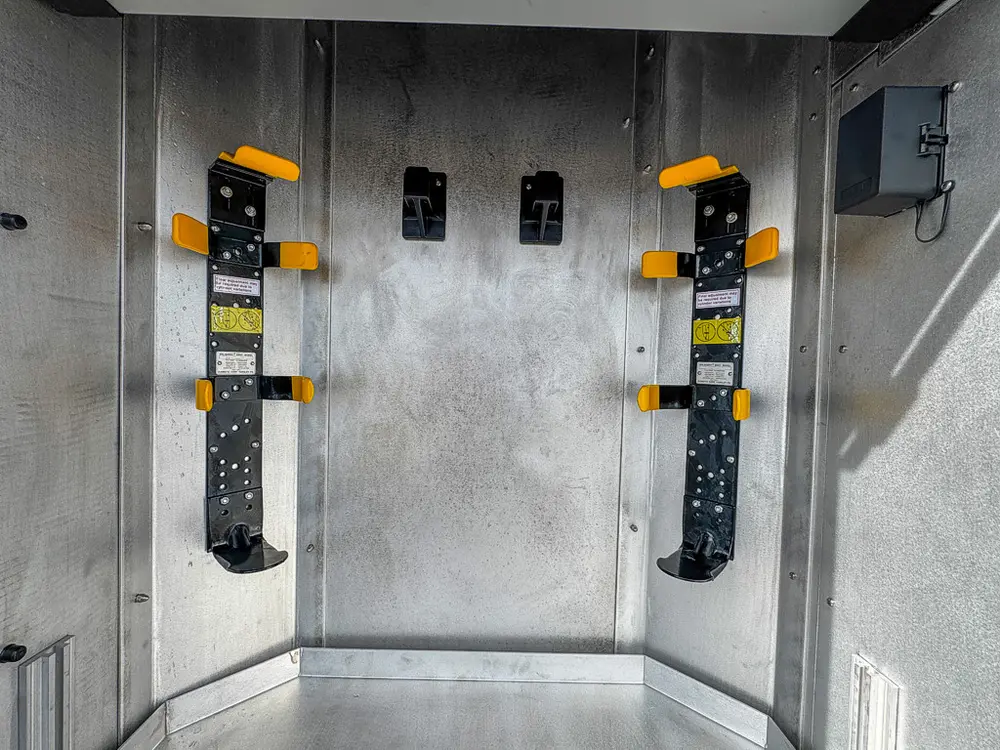 Close view of bracket mounts inside tall rear-side compartment.