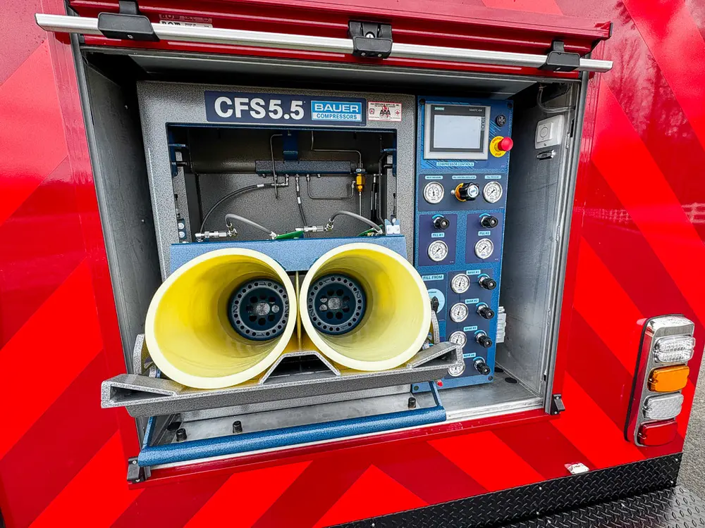 Rear fill station opened with dual yellow containment sleeves extended.