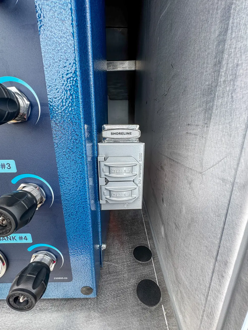 Small shoreline power outlet mounted beside rear control panel.