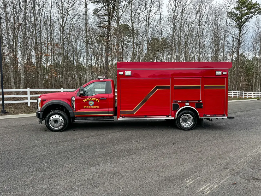 Full left-side profile of BRAT truck with compartment doors closed.