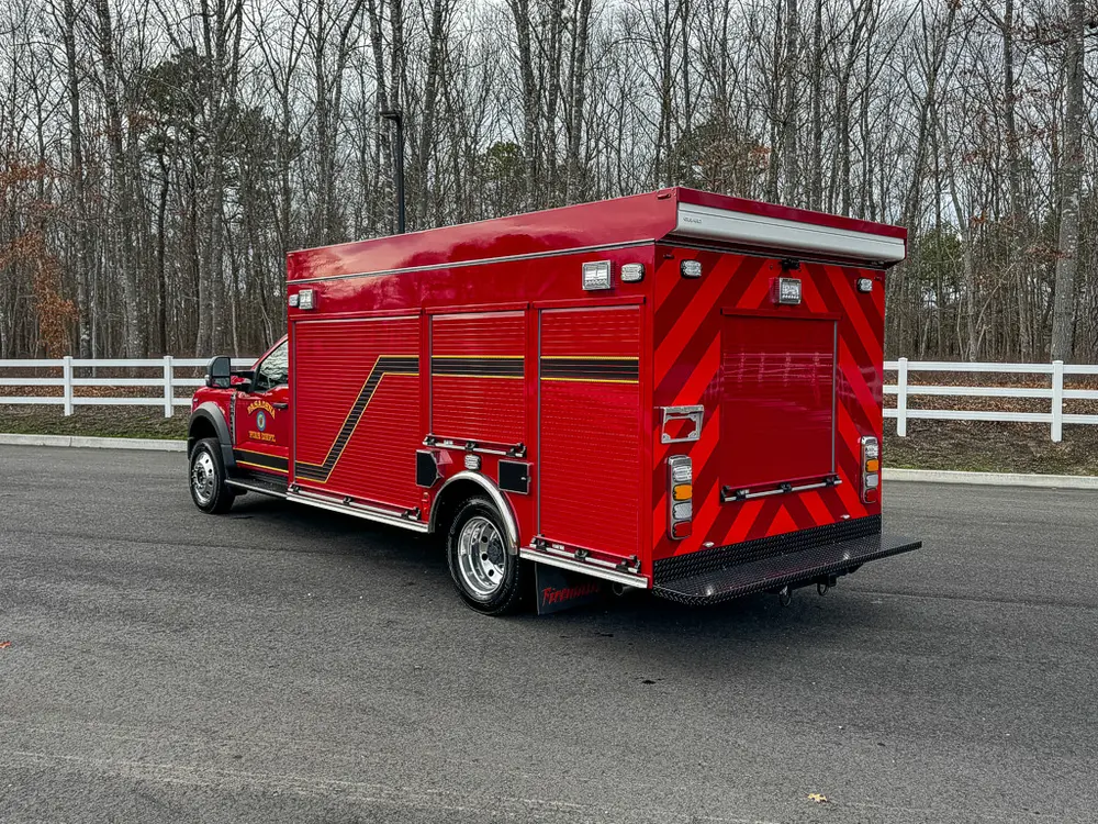 Rear-left exterior view showing chevron rear panel and side doors.