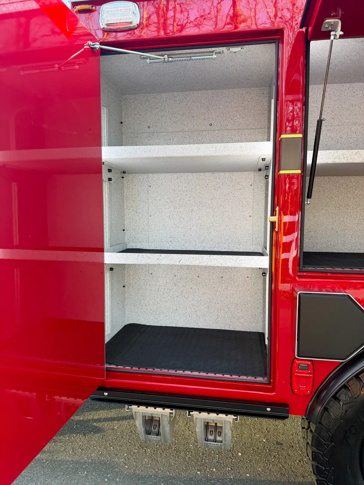 Close-up of vertical side compartment with three shelves.