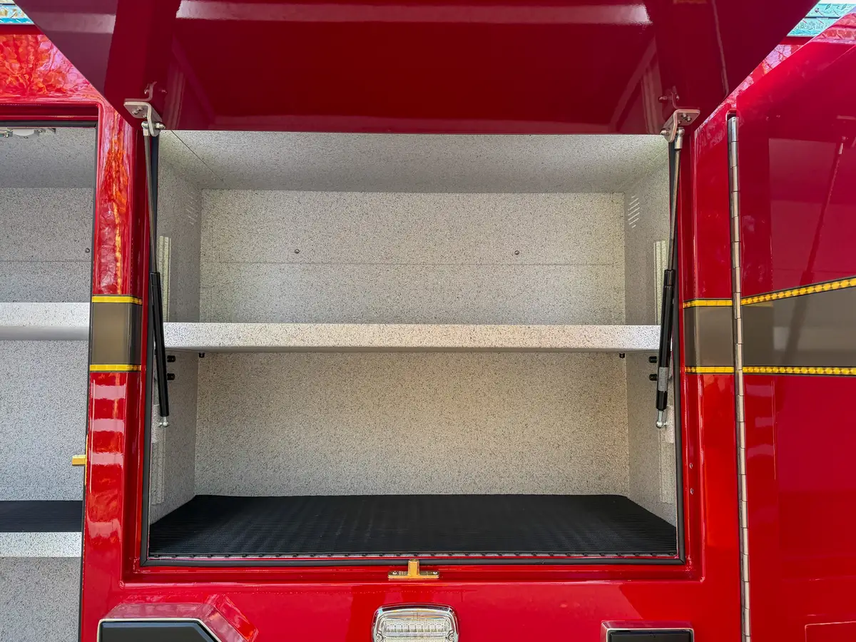 Close-up of center side compartment with upper shelf and rubberized floor.