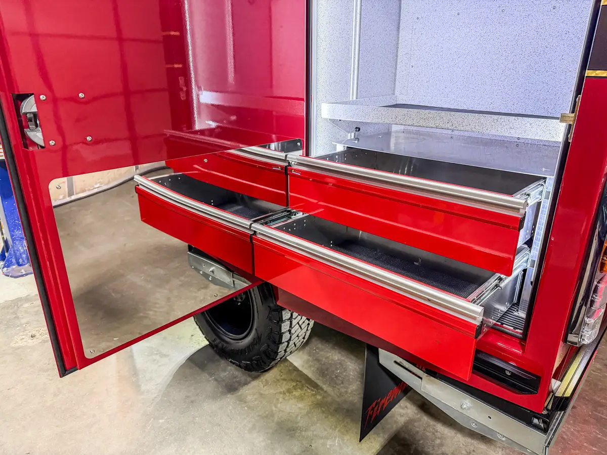 Compartment drawers extended outward from rear side storage bay.